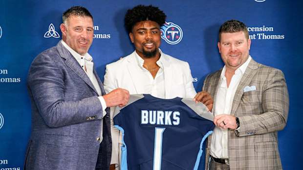 Tennessee Titans first round draft pick wide receiver Treylon Burks, center, holds up his jersey with head coach Mike Wrabel, left, and general manager Jon Robinson, right, during an introductory press conference at Saint Thomas Sports Park in Nashville, Tenn., Friday, April 29, 2022.